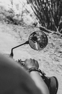 Close-up of hands gripping motorcycle handles, ready to set off on a temple road trip.