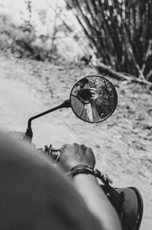 Close-up of hands gripping motorcycle handles, ready to set off on a temple road trip.