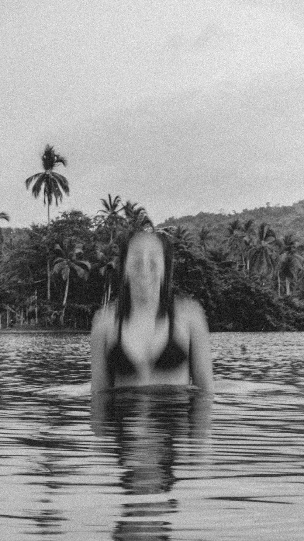a woman in a bikini floating in a body of water