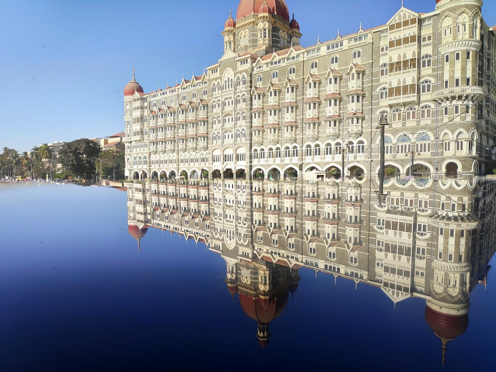 a large building is reflected in the water