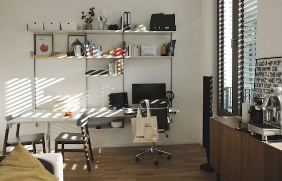 A clean, organized office desk area with shining floors and tidy surfaces.