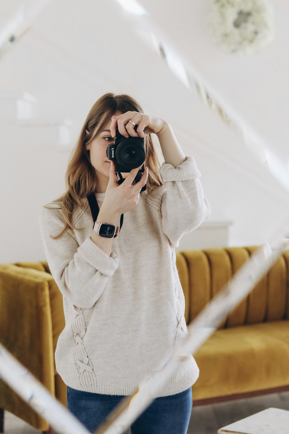 a woman taking a picture of herself in a mirror