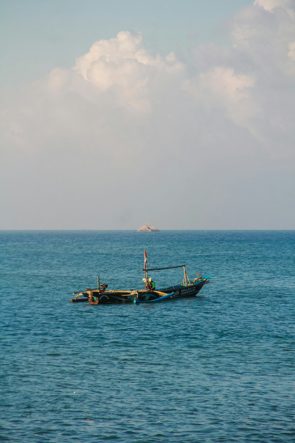 a couple of boats floating on top of a large body of water