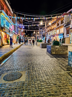 a cobblestone street in a city at night