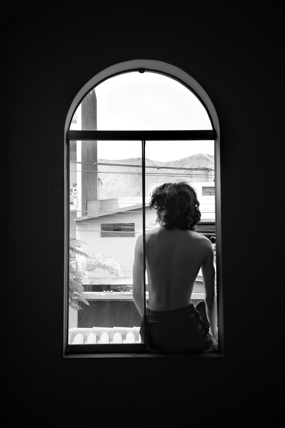 a woman is looking out of a window