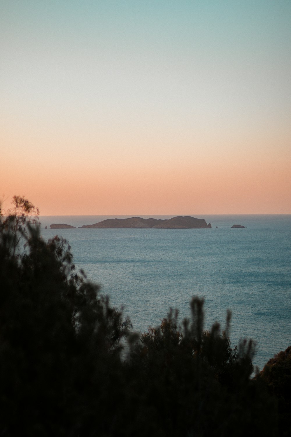 a body of water with a small island in the distance