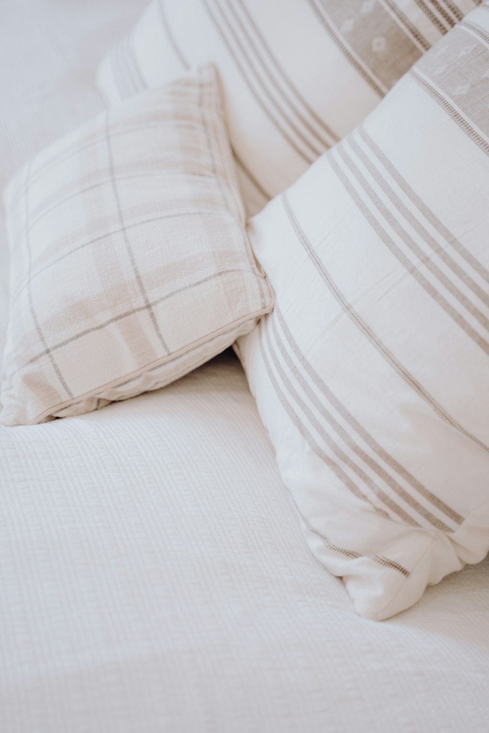 a close up of some pillows on a bed
