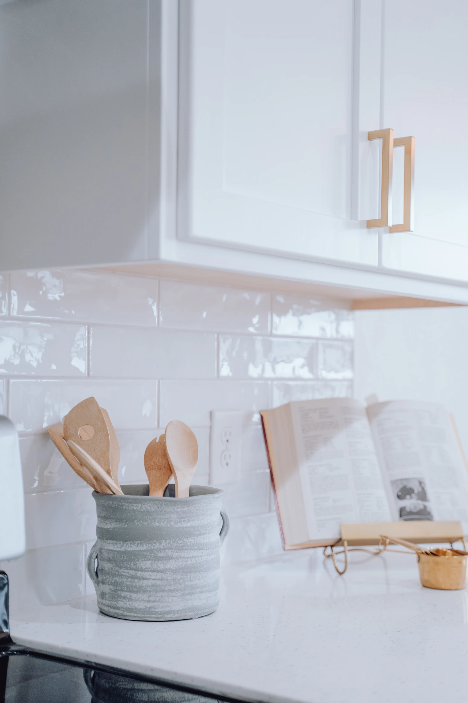 Warm kitchen counter with wooden utensils