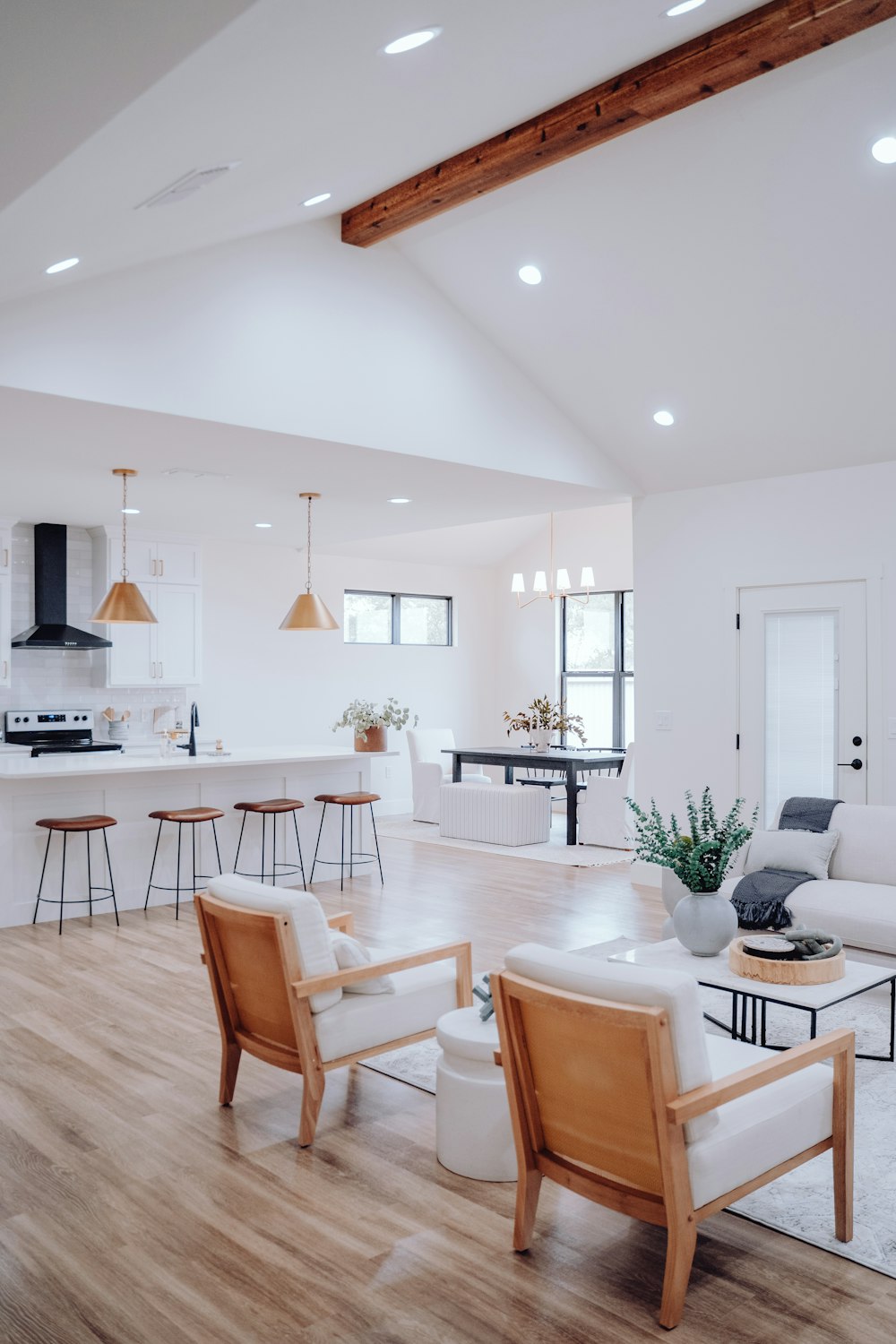 a living room filled with furniture and a kitchen