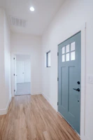a large empty room with a blue door