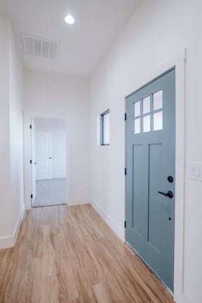 Bright hallway interior with freshly painted walls in white and blue tones.