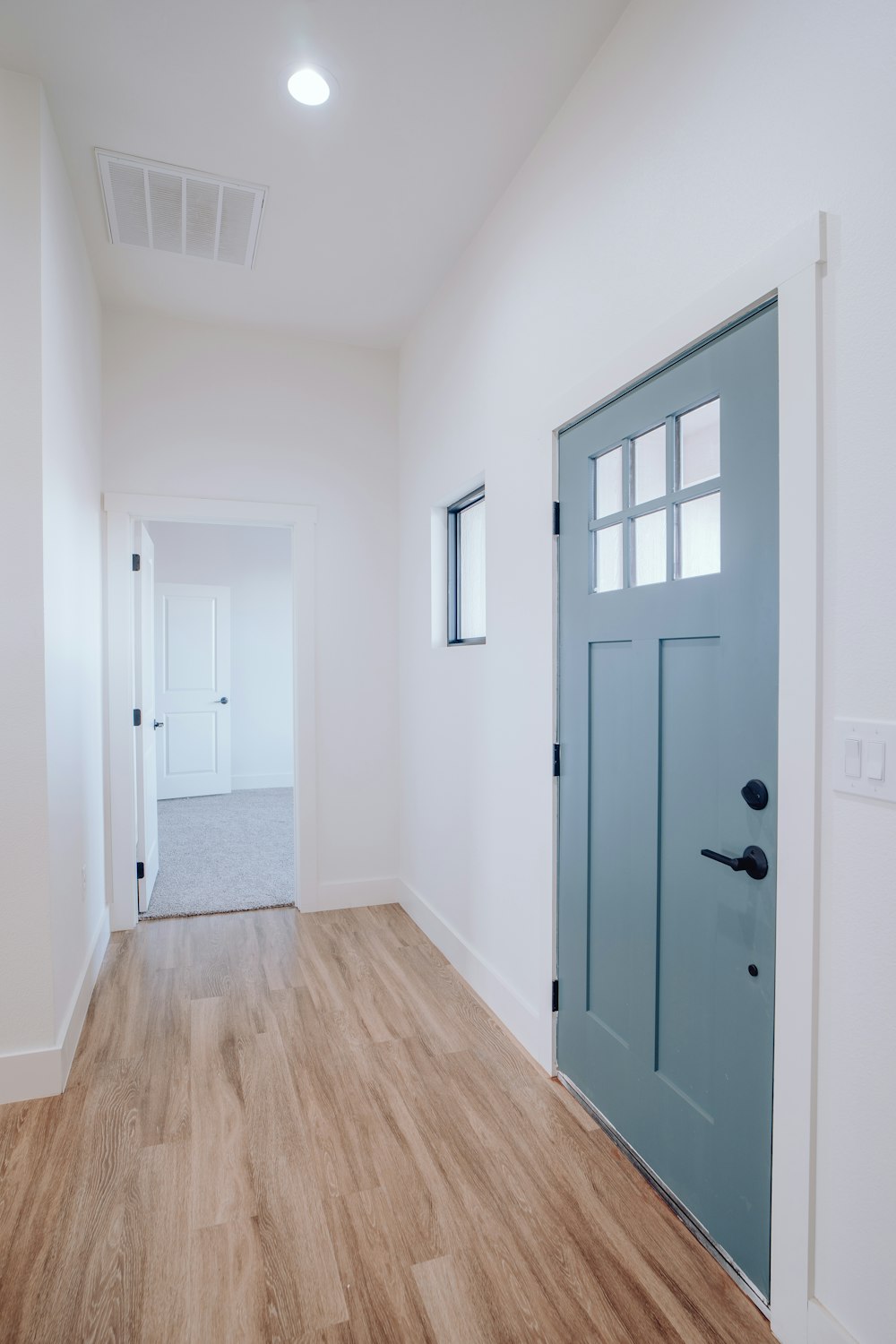 a large empty room with a blue door