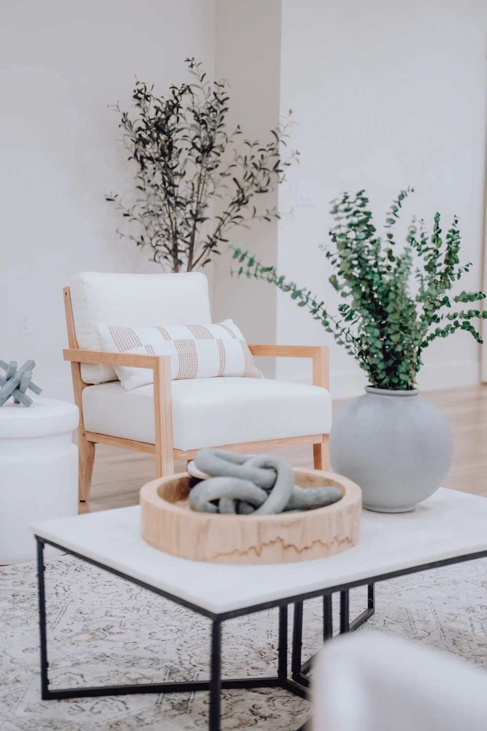 Carroll Gardens Duplex — pale seating with plants and textured ceramics