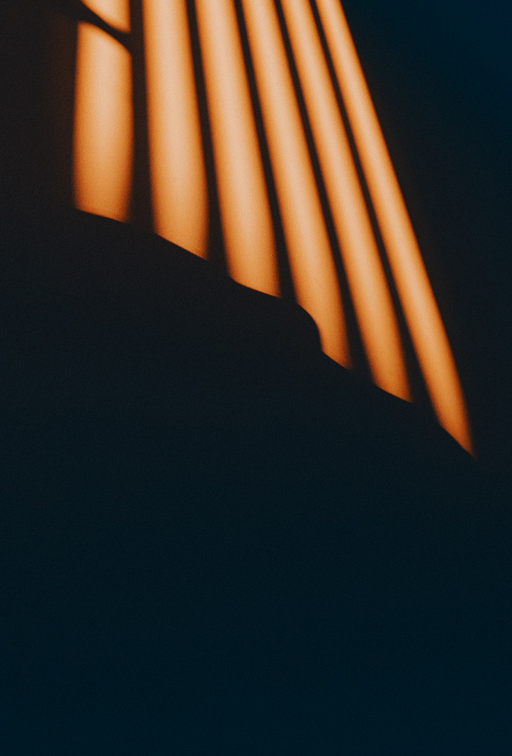 a black and orange photo of a light coming through a window