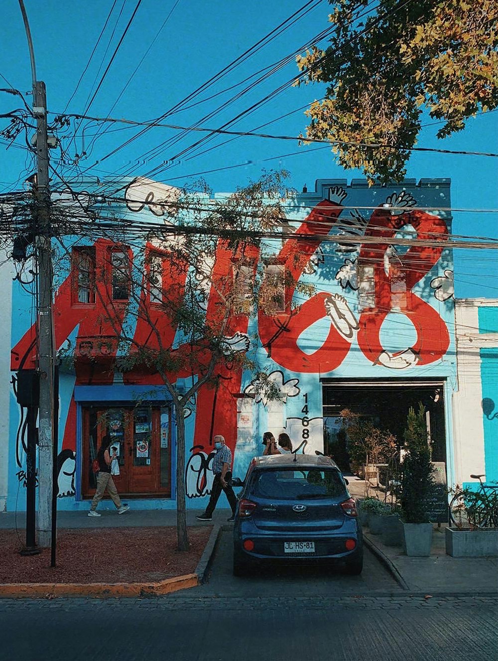 a blue car parked in front of a building