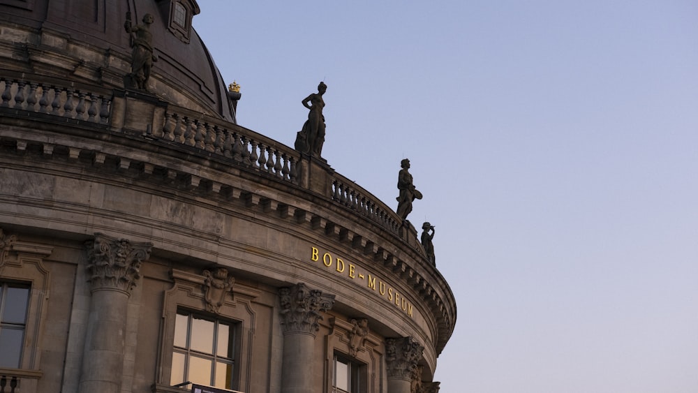 a large building with statues on top of it