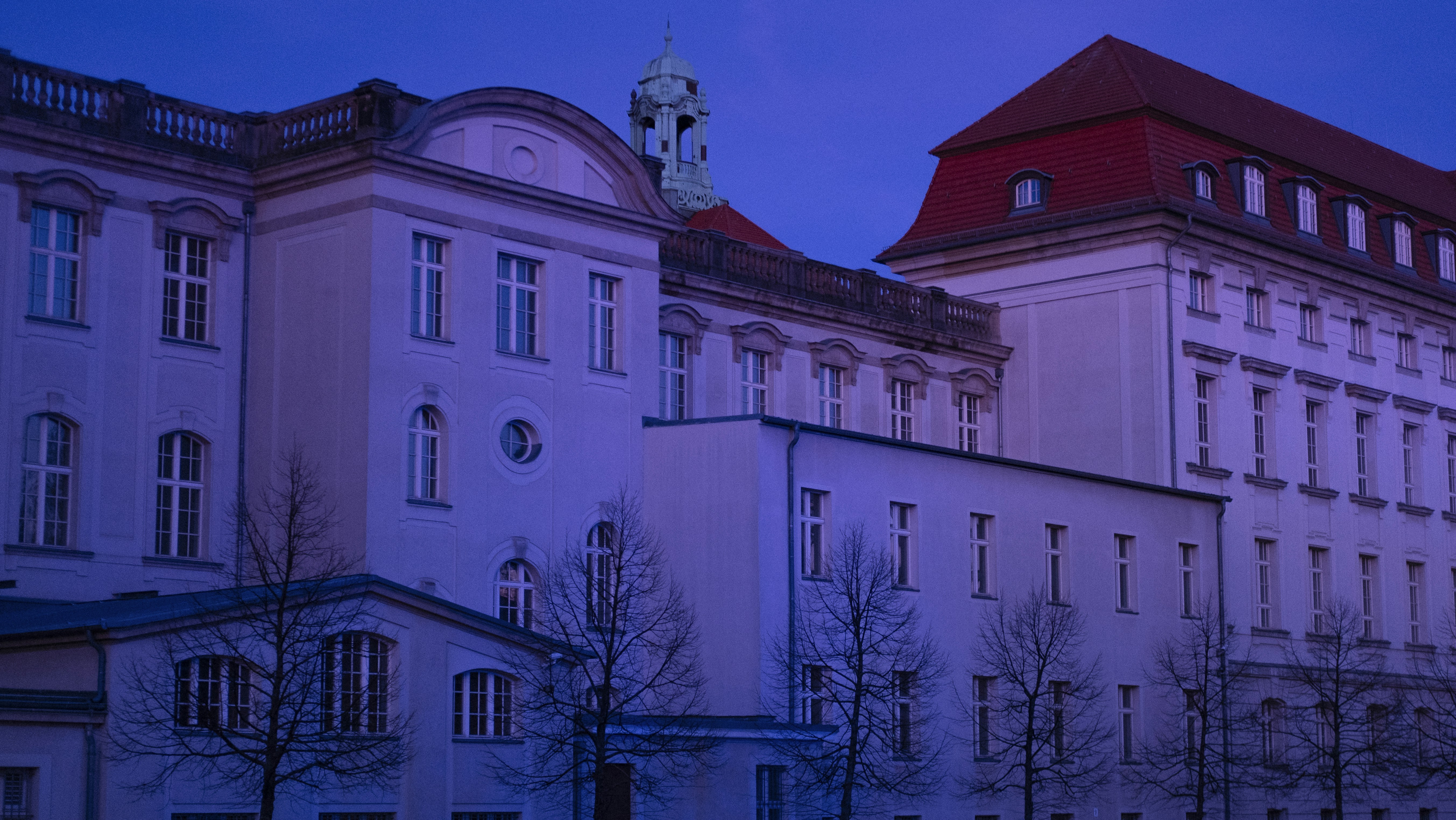 a large white building with a clock tower