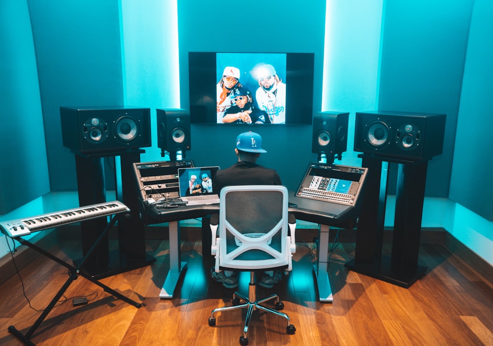 a man sitting in front of a keyboard in a room