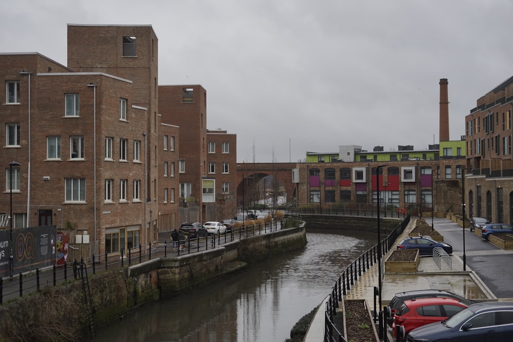 a river running through a city next to tall buildings