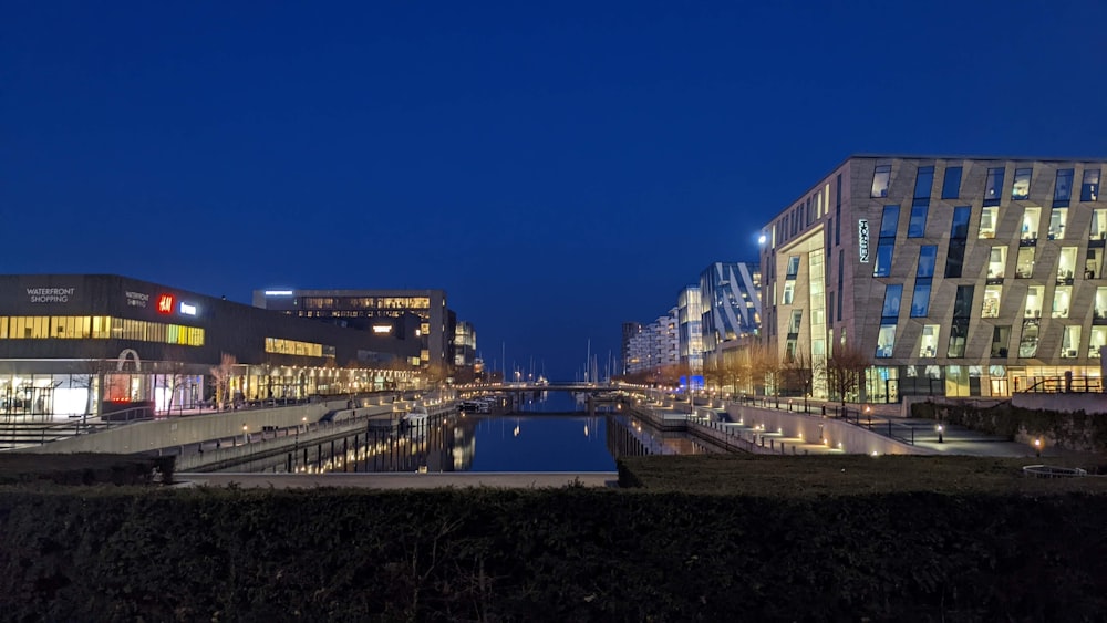 a city at night with a canal in the foreground