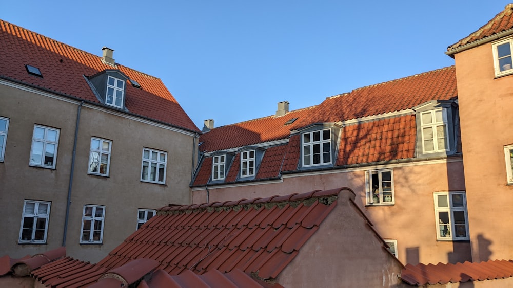 a row of buildings with red tiled roofs