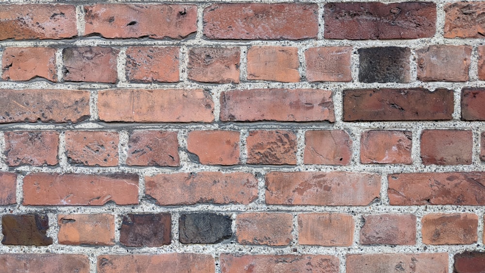 a close up of a brick wall made of red bricks