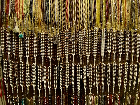 Array of colorful glass beads displayed on a wooden surface.