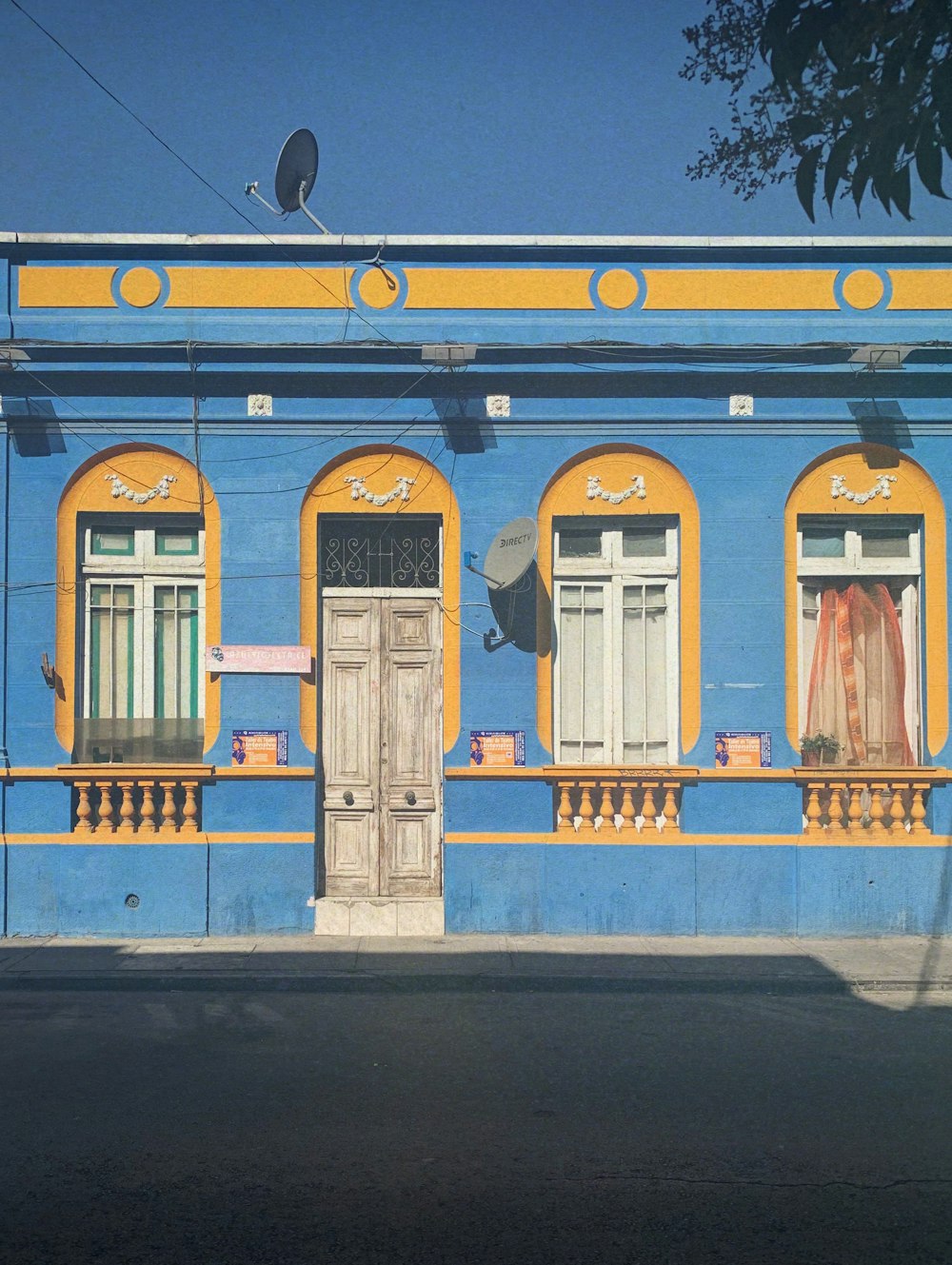 a blue building with yellow trim and windows