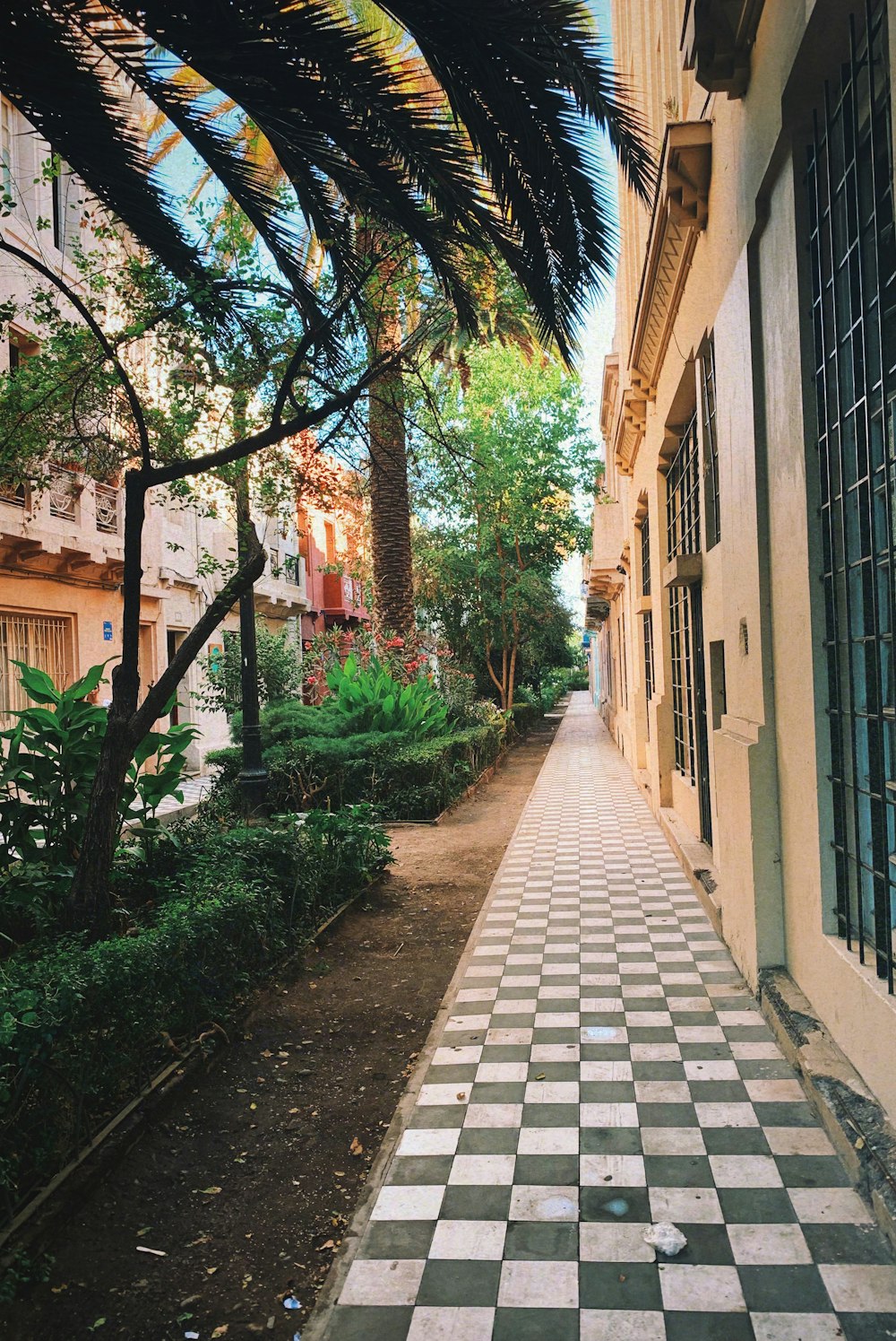 a black and white checkered sidewalk next to a building