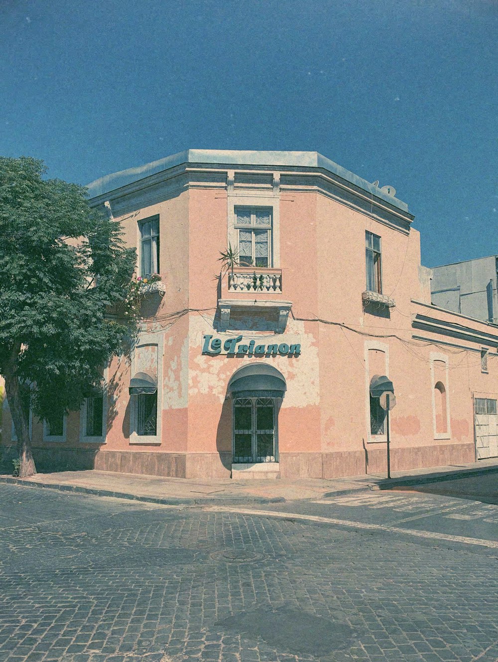 a pink building with a clock on the front of it