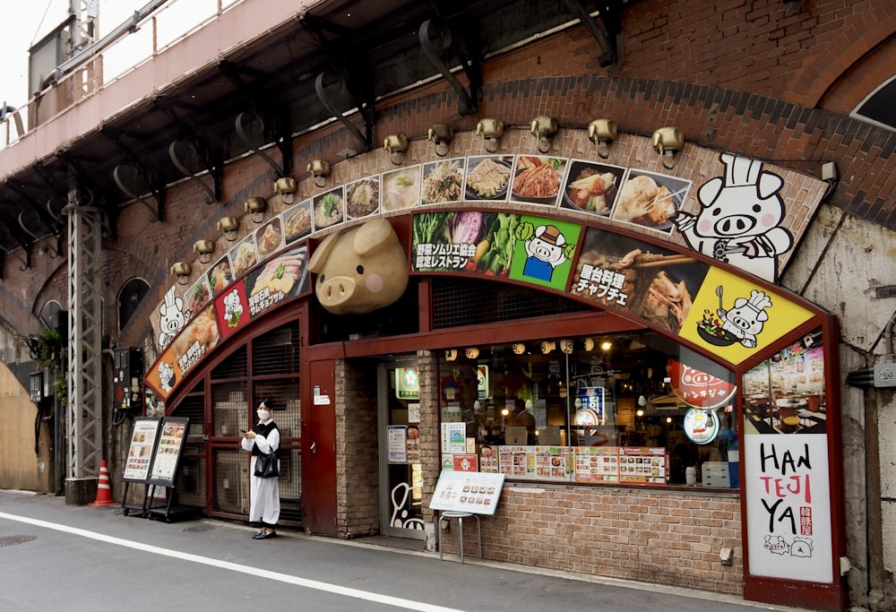 a person standing outside of a restaurant