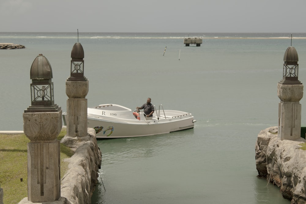 a man is sitting on a boat in the water