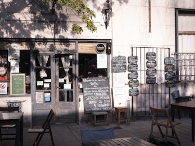 A rustic wooden sign displaying the daily changing menu outside the restaurant.