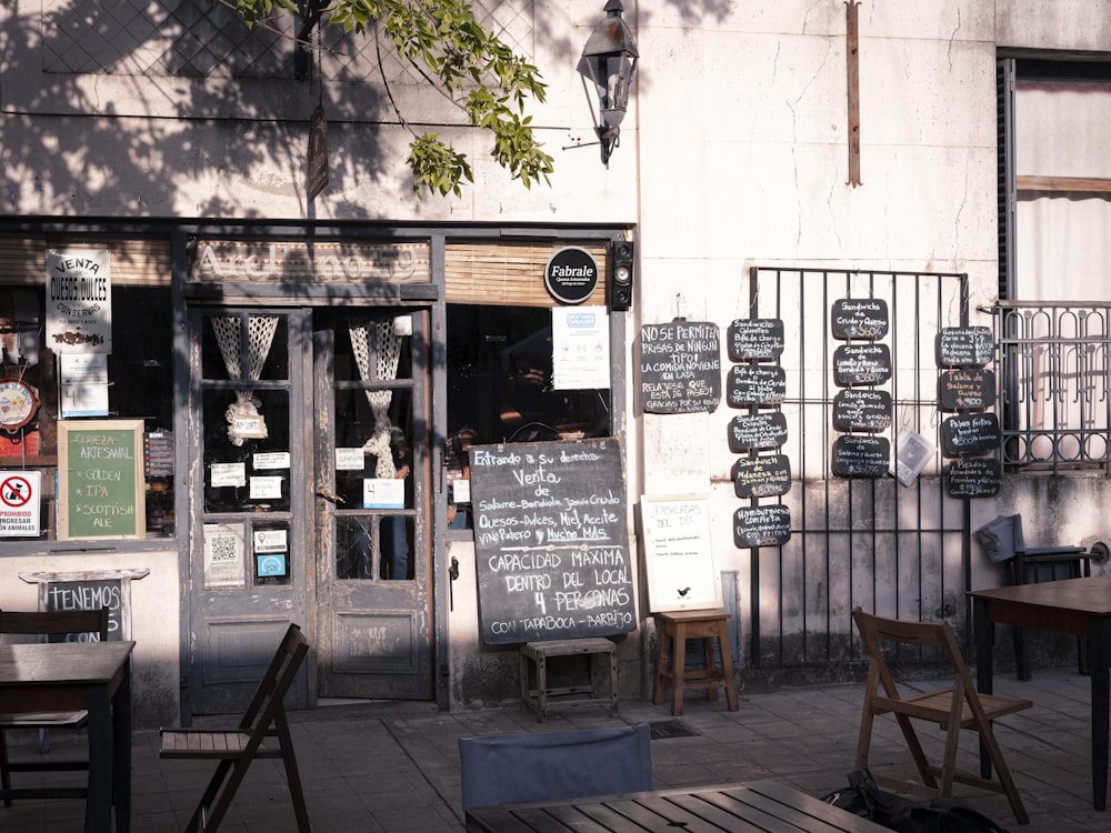 a restaurant with tables and chairs outside of it