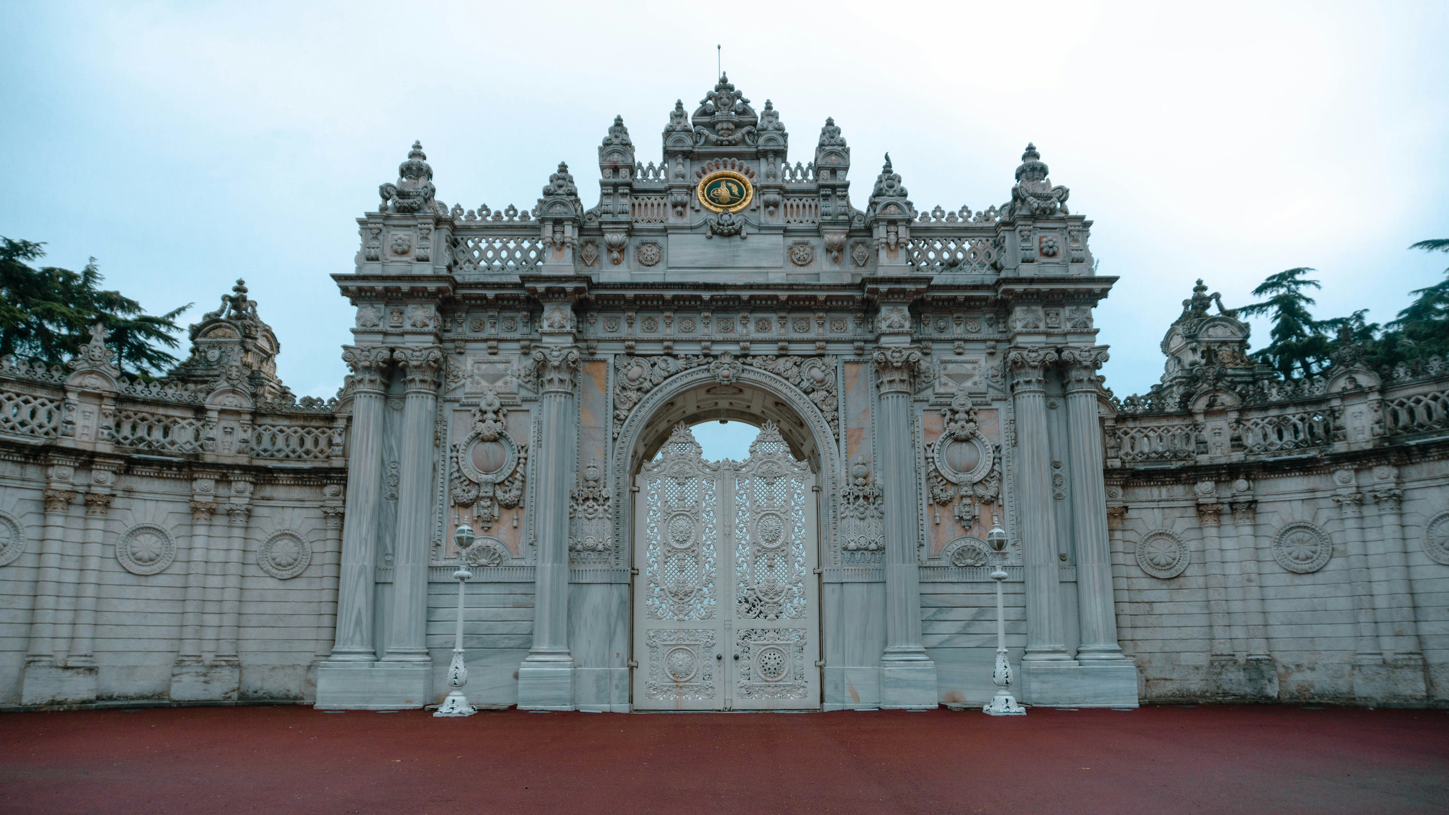 A large white gate with a clock on top of it photo – Free Grey Image on ...