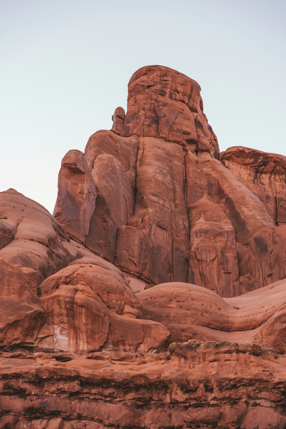 a large rock formation in the middle of a desert