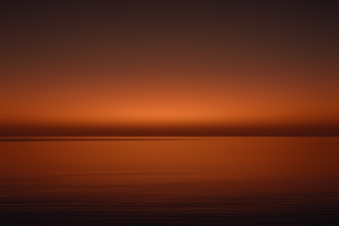 the sun is setting over the horizon of a body of water, Sunset in motion