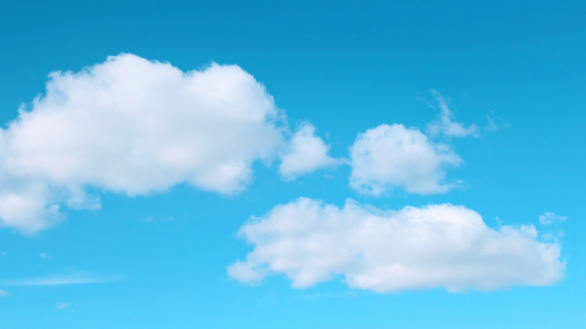 a plane flying in the sky with a cloud in the background