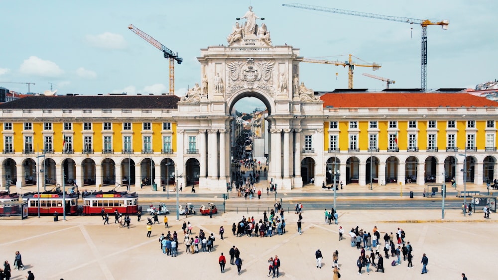 a group of people standing in front of a large building