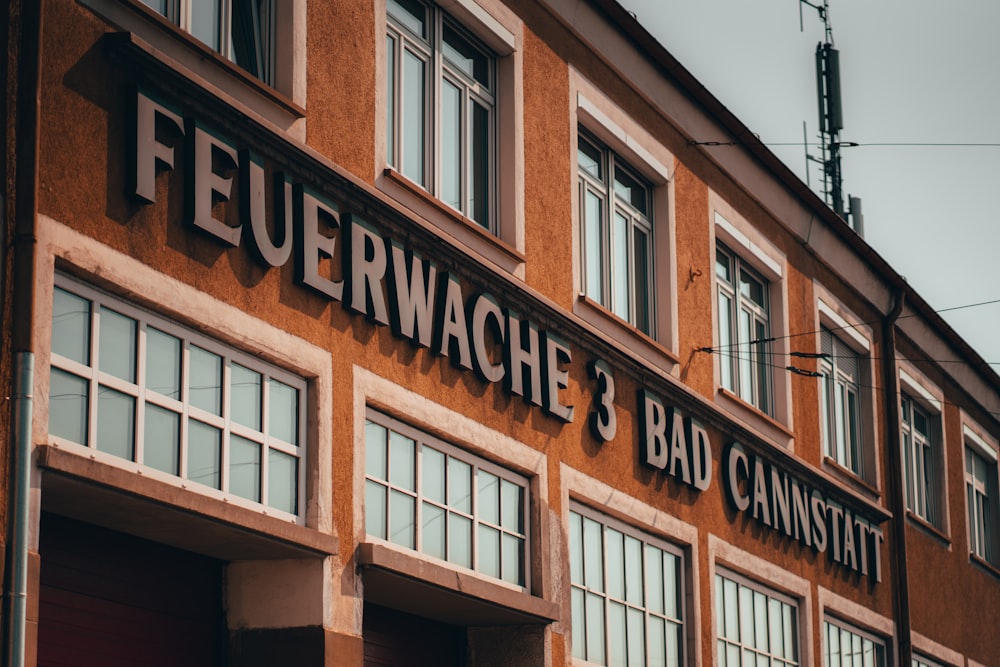 a red building with a sign that says feuerwache 3 bad cannst