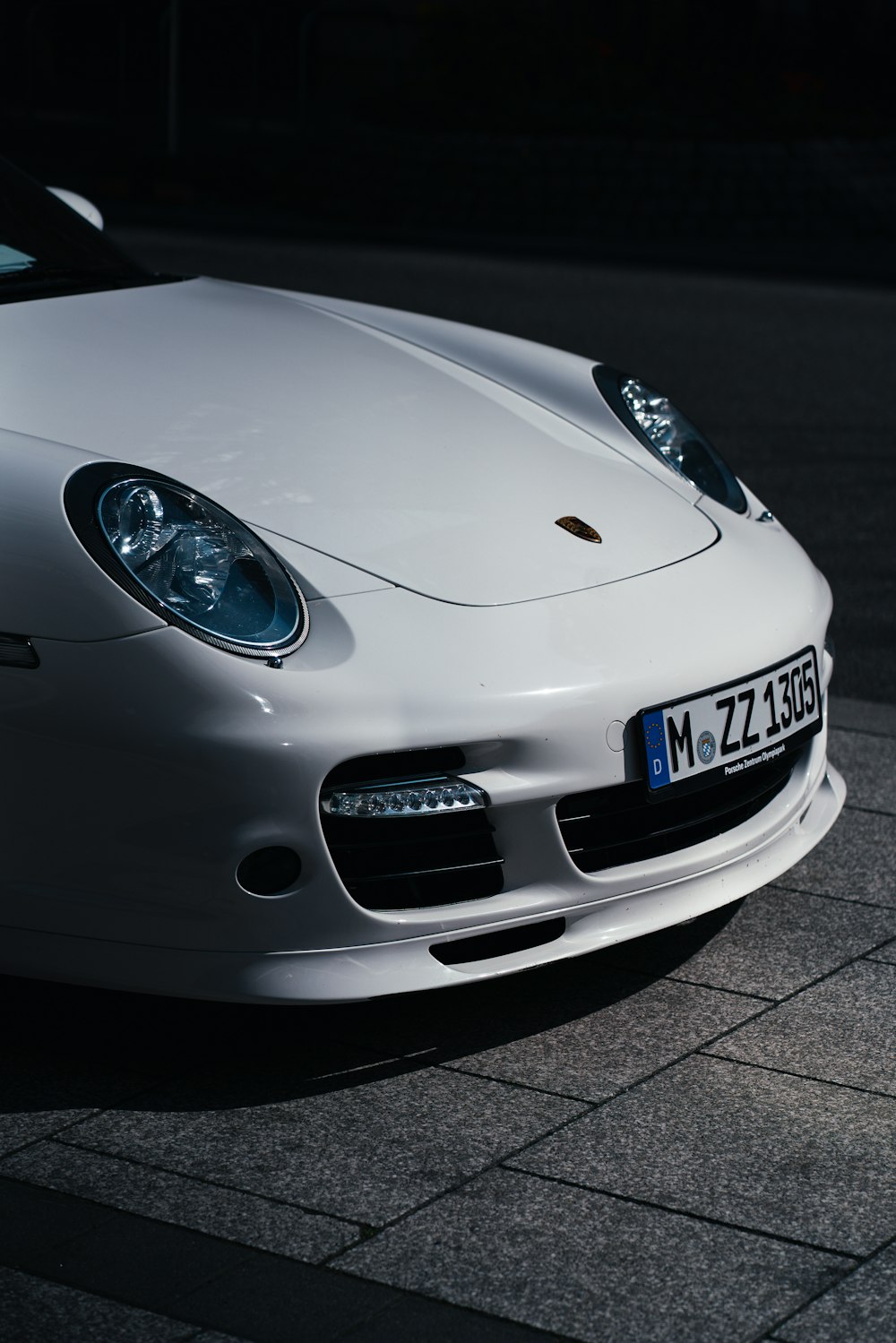 a white sports car parked on the side of the road