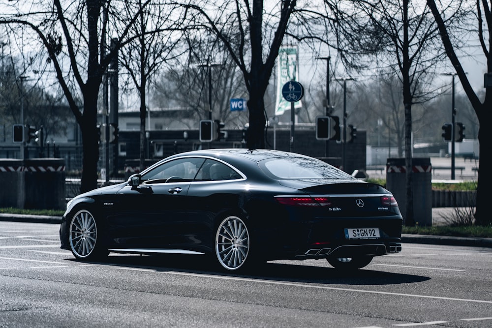 a black car parked on the side of the road