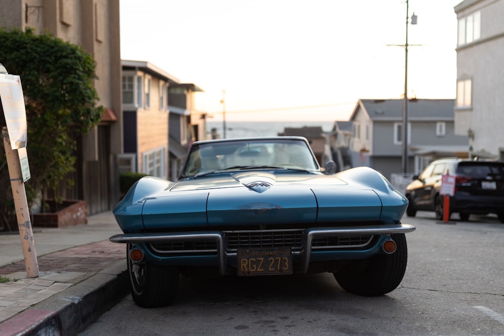 a blue car parked on the side of the road