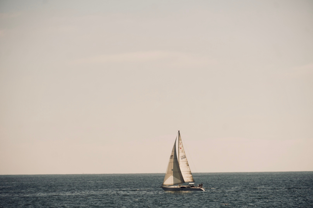 a sailboat in the middle of the ocean