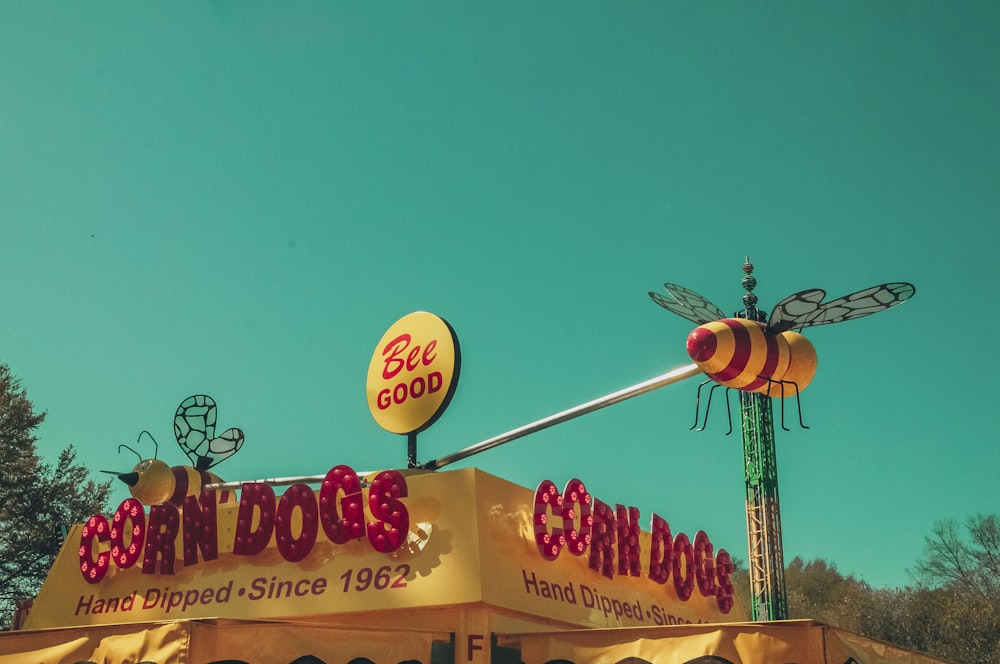 a large sign with a bee on top of it