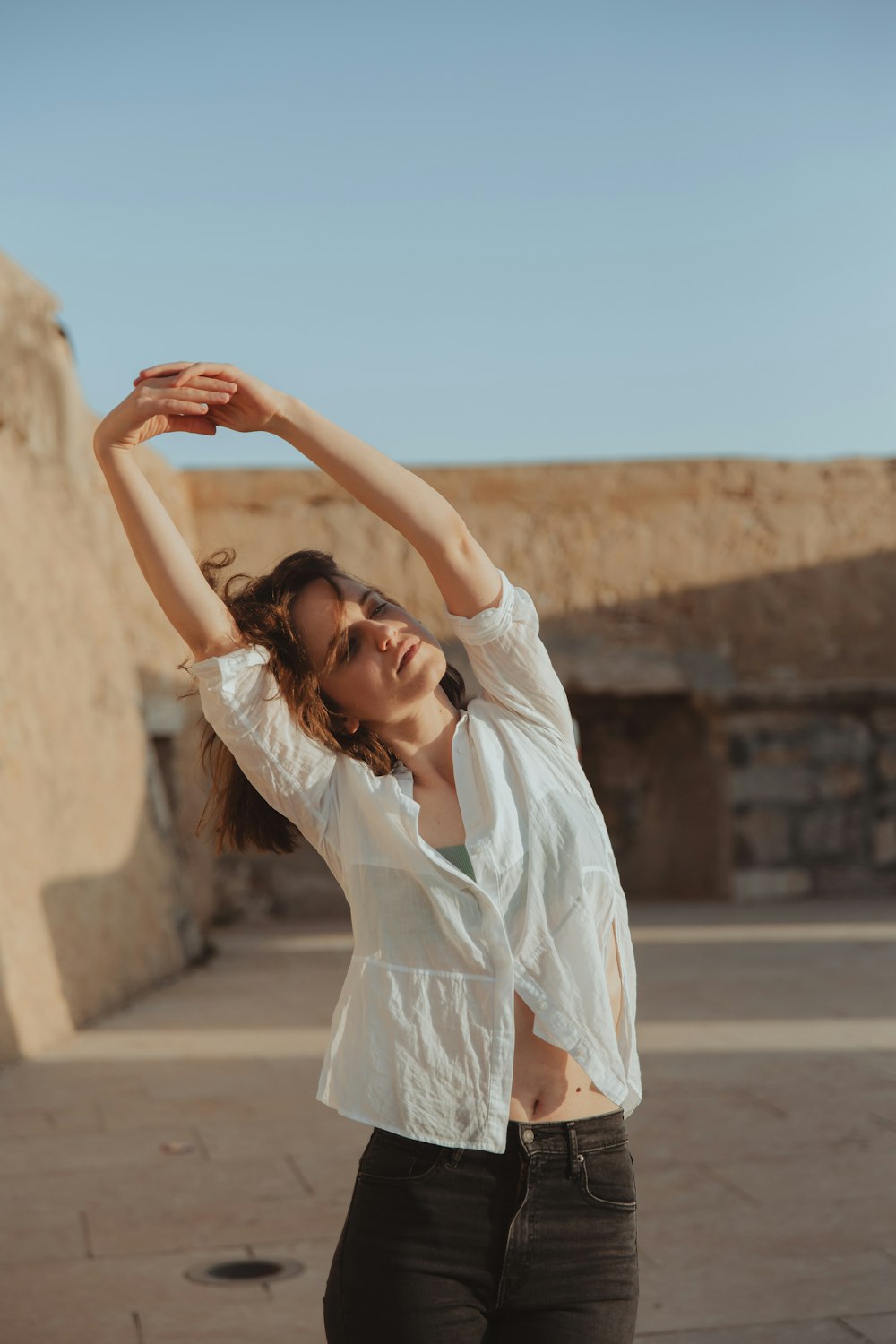 a woman in a white shirt and black pants