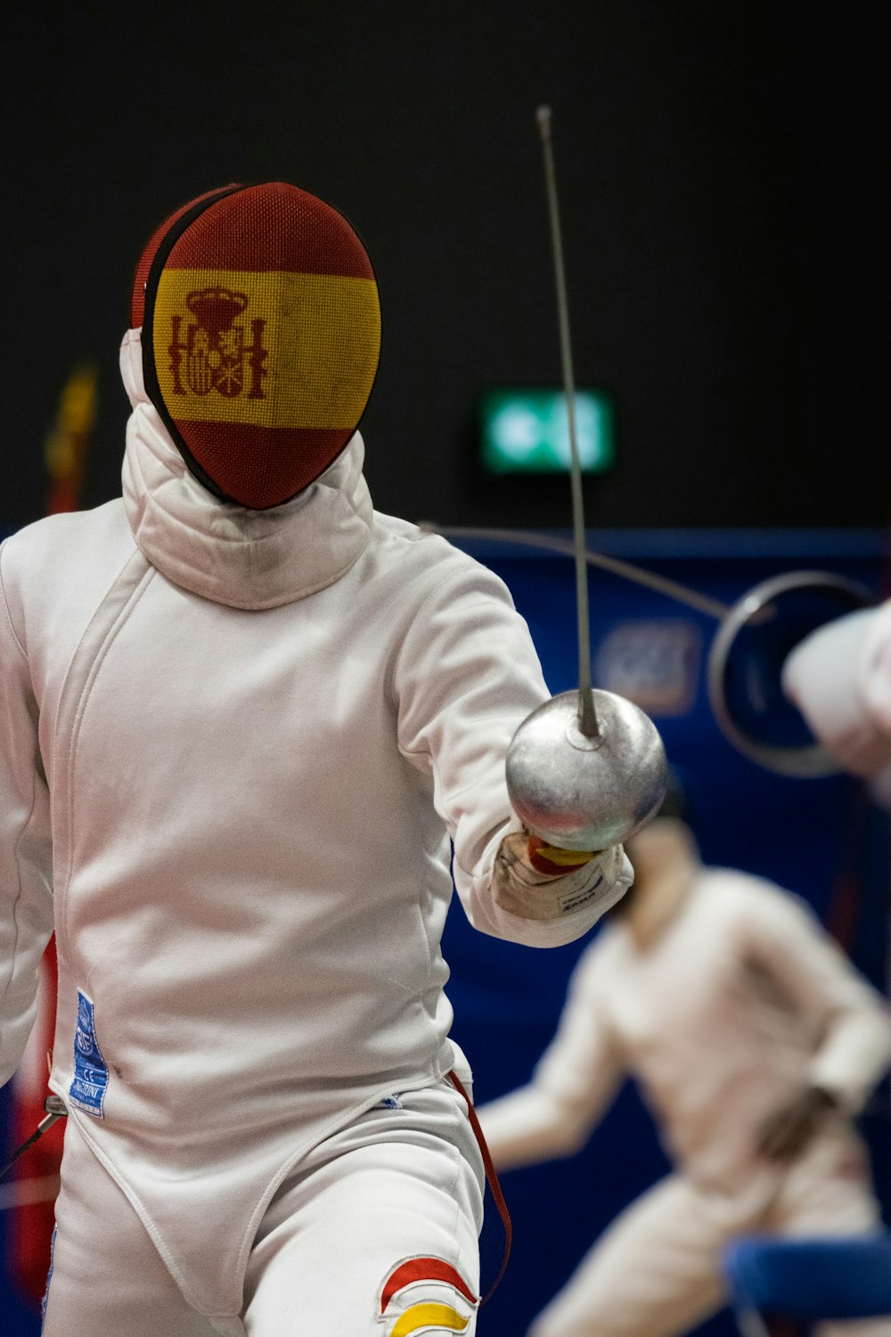 a person in a fencing outfit holding a ball