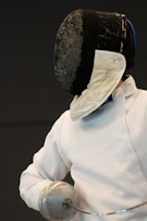 a person wearing a white shirt and a black hat