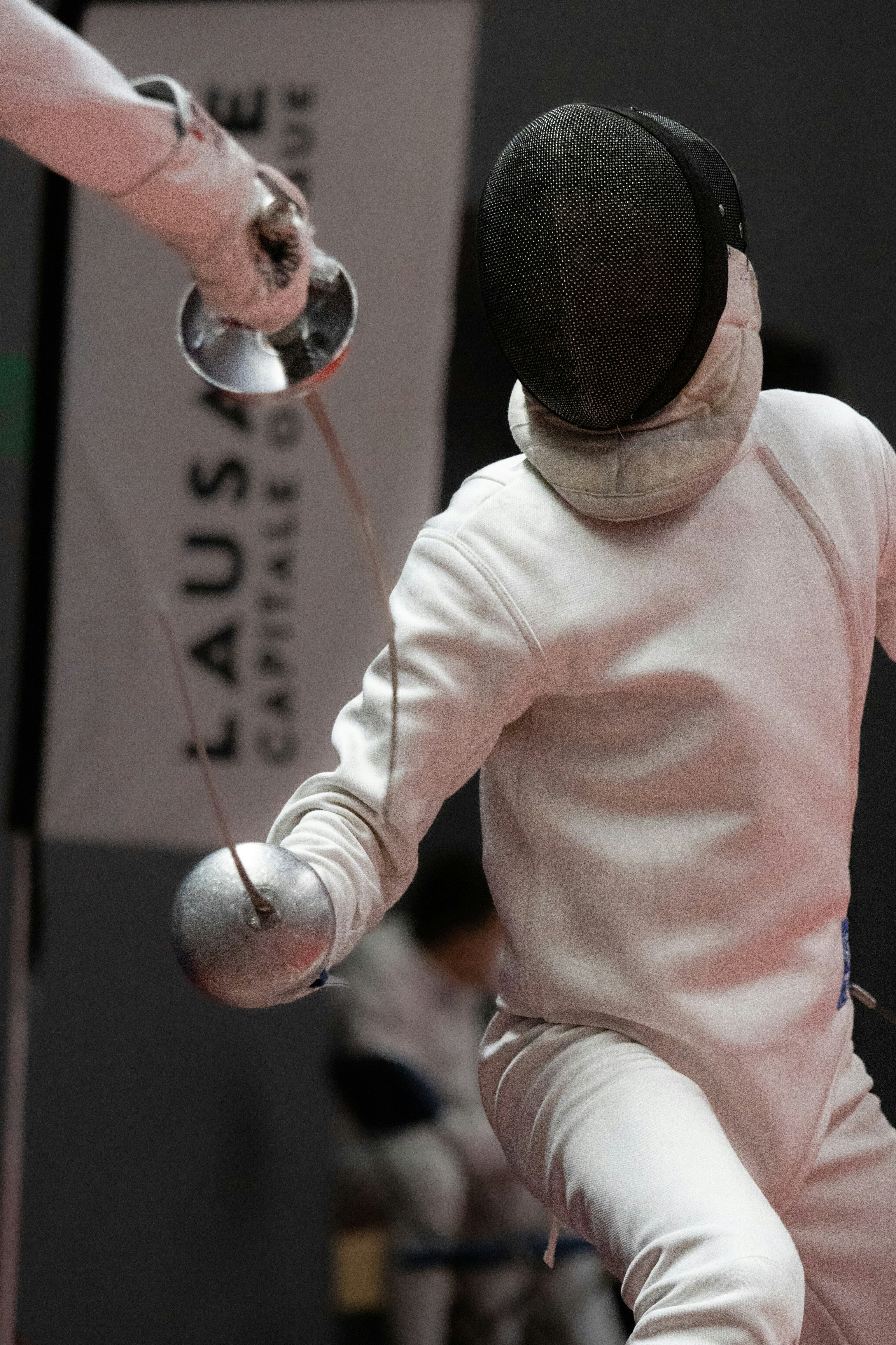 a person in a white suit holding a silver object