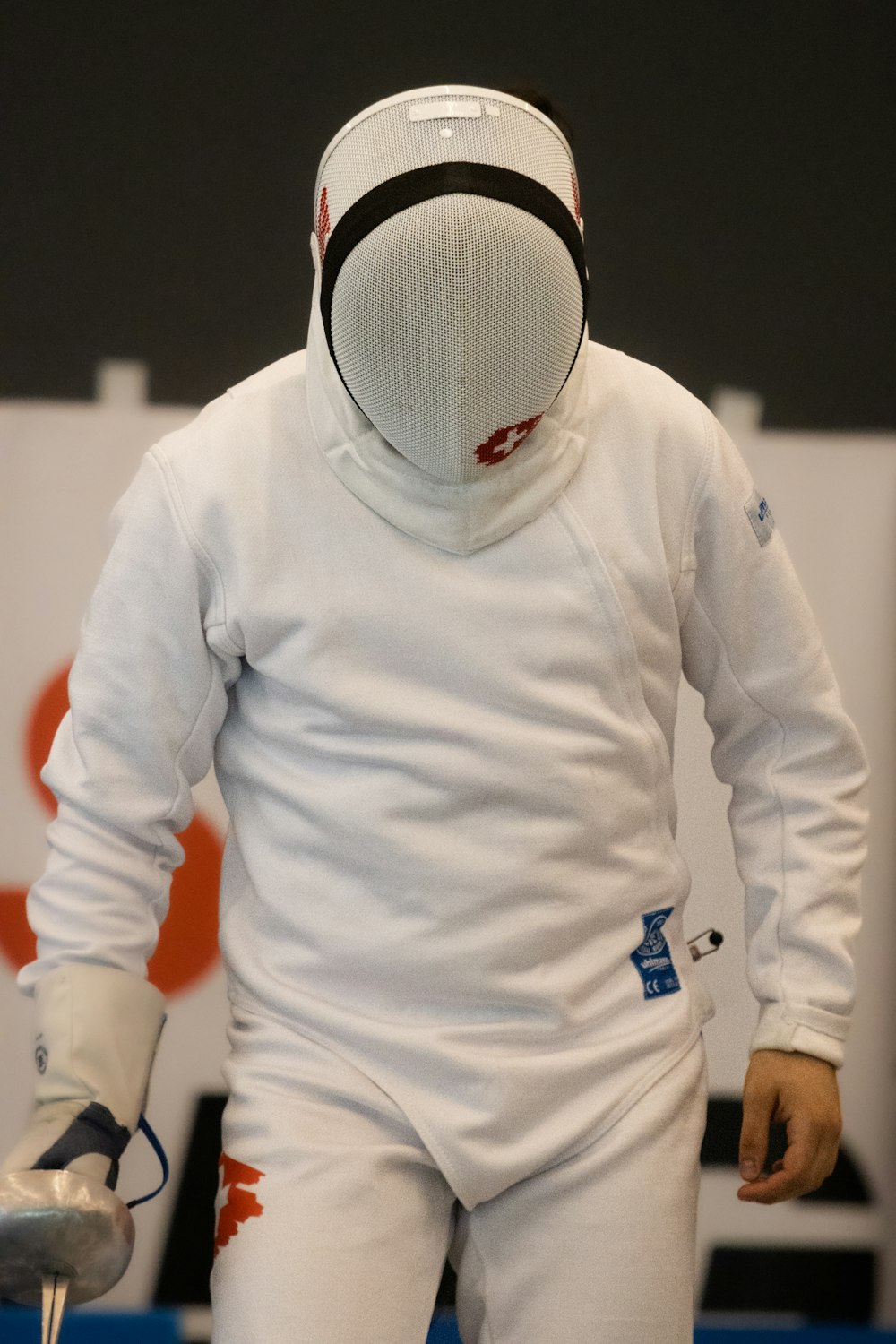 a person wearing a white suit and mask